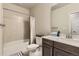 This bathroom includes a tub and shower with a combo, vanity, and neutral tiling at 476 Silver Rock Trl, Castle Rock, CO 80104