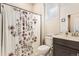 This bathroom has a floral shower curtain and great natural lighting from the window at 476 Silver Rock Trl, Castle Rock, CO 80104