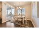 Bright and airy dining area featuring a table with seating for six and sliding glass doors to the patio at 476 Silver Rock Trl, Castle Rock, CO 80104