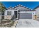 Charming single-Gathering home with stone accents, landscaped front yard, and a two-car garage at 476 Silver Rock Trl, Castle Rock, CO 80104