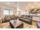 Spacious living room with leather sofas and an open layout leading to the kitchen and dining area at 476 Silver Rock Trl, Castle Rock, CO 80104