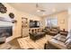 Inviting living room featuring a fireplace, large TV, comfortable leather seating, and plenty of natural light at 476 Silver Rock Trl, Castle Rock, CO 80104