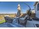 This patio features stylish furniture, an umbrella and great views at 476 Silver Rock Trl, Castle Rock, CO 80104