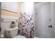 Clean and bright bathroom with a floral shower curtain and ample natural light at 1020 15Th St # 32K, Denver, CO 80202