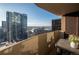 Balcony view of city buildings, with table and chairs for outdoor enjoyment at 1020 15Th St # 32K, Denver, CO 80202