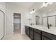 Modern bathroom with double vanity, large mirror, and sleek black fixtures at 2839 E 103Rd Dr, Thornton, CO 80229