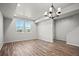 Bright dining room with wood floors, two windows and a modern chandelier at 2839 E 103Rd Dr, Thornton, CO 80229