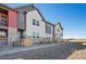 Eye-level view of charming townhomes with a fenced yard and modern color scheme at 2839 E 103Rd Dr, Thornton, CO 80229