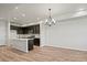 Modern kitchen featuring dark cabinets, a quartz island, stainless steel appliances, and recessed lighting at 2839 E 103Rd Dr, Thornton, CO 80229