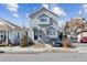 Inviting gray two-story home with classic design, complemented by a well-maintained front yard at 4445 Pearl St, Denver, CO 80216