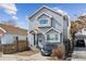 Inviting two-story home with gray siding, landscaped yard, and off-street parking, showcasing comfort and convenience at 4445 Pearl St, Denver, CO 80216