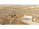 High-altitude view of a vast expanse of land featuring outbuildings and corrals at 6201 S Vanderhoof St, Bennett, CO 80102