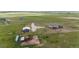 Wide aerial view showcasing three structures on the property including pens for horses and other livestock at 6201 S Vanderhoof St, Bennett, CO 80102