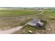 Aerial view of back of the house, deck and propane tank on large lot with native prairie grass at 6201 S Vanderhoof St, Bennett, CO 80102