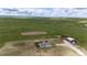 Expansive aerial view of the property with a house, barn, and large open fields with mountain views at 6201 S Vanderhoof St, Bennett, CO 80102