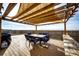 Inviting back deck with a dining table under a pergola, perfect for outdoor dining and entertaining, with a scenic view at 6201 S Vanderhoof St, Bennett, CO 80102