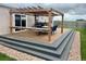 Backyard deck with a pergola providing shade for outdoor dining and entertaining at 6201 S Vanderhoof St, Bennett, CO 80102