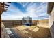 Backyard featuring a trampoline with safety net, providing a fun and safe play area, set against an open sky at 6201 S Vanderhoof St, Bennett, CO 80102