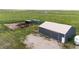 Large metal barn for storage and shelter with multiple animal pens and storage containers at 6201 S Vanderhoof St, Bennett, CO 80102