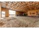 Open barn interior with a large door to the outside, great for equipment storage or livestock, with ample natural light at 6201 S Vanderhoof St, Bennett, CO 80102
