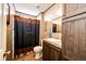 The bathroom has a sink, vanity, mirror, toilet, and a shower curtain at 6201 S Vanderhoof St, Bennett, CO 80102