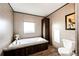 This bathroom has a tub, window, toilet, and vanity at 6201 S Vanderhoof St, Bennett, CO 80102