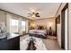 The bedroom features a bed with bedding, light, window, and decorative rug at 6201 S Vanderhoof St, Bennett, CO 80102