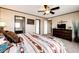This bedroom features a bed with bedding, dresser, TV, mirror, and a rug at 6201 S Vanderhoof St, Bennett, CO 80102