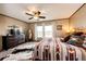 This bedroom features a bed with bedding, dresser, TV, mirror, and a rug at 6201 S Vanderhoof St, Bennett, CO 80102