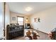 The bedroom includes a crib, rug, picture, bedside table, and a window at 6201 S Vanderhoof St, Bennett, CO 80102
