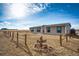 Charming single-Gathering home featuring a bright red front door and a rustic cactus decoration in the yard at 6201 S Vanderhoof St, Bennett, CO 80102
