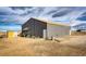 Spacious and well-maintained metal garage with ample storage space for vehicles and equipment at 6201 S Vanderhoof St, Bennett, CO 80102