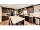 Well-lit kitchen featuring stainless steel appliances, custom cabinets, and a center island at 6201 S Vanderhoof St, Bennett, CO 80102