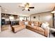 Cozy living room with large sectional sofa, carpet and open to the kitchen and dining area at 6201 S Vanderhoof St, Bennett, CO 80102