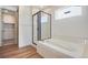Bathroom with soaking tub and walk-in shower with glass door and tile surround, and a walk-in closet at 24593 E 34Th Ave, Aurora, CO 80019