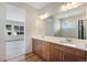Bright bathroom with double vanity, large mirror, and combination shower and tub with glass door at 24593 E 34Th Ave, Aurora, CO 80019