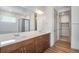 Bathroom with double vanity, quartz countertops, tile backsplash, a modern mirror, and walk-in shower at 24593 E 34Th Ave, Aurora, CO 80019