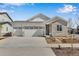 Charming single Gathering home featuring a three car garage, stone accents, and manicured landscaping at 24593 E 34Th Ave, Aurora, CO 80019