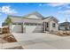 Charming single Gathering home featuring a three car garage, stone accents, and manicured landscaping at 24593 E 34Th Ave, Aurora, CO 80019