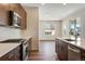 Modern kitchen with stainless appliances, gas range, and view to the bright living space at 24593 E 34Th Ave, Aurora, CO 80019