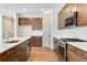 Kitchen with island and stainless steel appliances, ample counter space, and crisp white backsplash at 24593 E 34Th Ave, Aurora, CO 80019