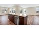 Kitchen island with stainless steel dishwasher and sink overlooking windows to the outdoors at 24593 E 34Th Ave, Aurora, CO 80019