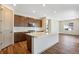 Modern kitchen boasts stainless steel appliances, a stylish island, and sleek brown cabinetry at 24593 E 34Th Ave, Aurora, CO 80019