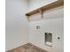 Laundry room with upper shelf, light walls, and tile flooring at 24593 E 34Th Ave, Aurora, CO 80019