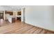 Spacious living room with wood-look floors and access to the kitchen showcasing modern finishes at 24593 E 34Th Ave, Aurora, CO 80019