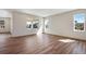 Spacious living room with multiple windows and laminate wood flooring at 24593 E 34Th Ave, Aurora, CO 80019