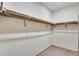 Neutral walk-in closet with closet rod and shelving system for optimal wardrobe storage at 24593 E 34Th Ave, Aurora, CO 80019