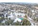 Aerial view of community, tennis court, and pond in winter setting at 23694 Pondview Pl # B, Golden, CO 80401