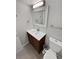 Bathroom featuring a cherry wood vanity, tiled wall, and modern fixtures at 7251 S Xenia Cir # B, Centennial, CO 80112