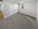 Bedroom featuring a large closet, neutral carpet, and a view out of the window at 7251 S Xenia Cir # B, Centennial, CO 80112